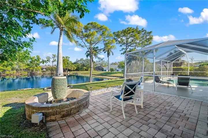 View of patio / terrace with glass enclosure and a water view