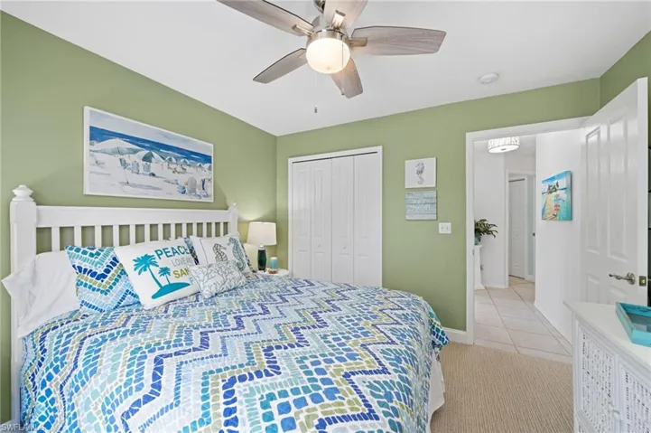 Tiled bedroom with a closet and ceiling fan