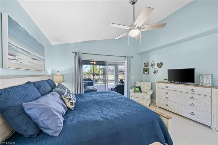 Carpeted bedroom with access to outside, ceiling fan, and lofted ceiling
