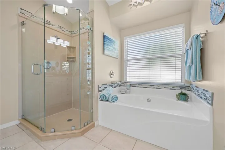 Bathroom featuring tile patterned floors and separate shower and tub