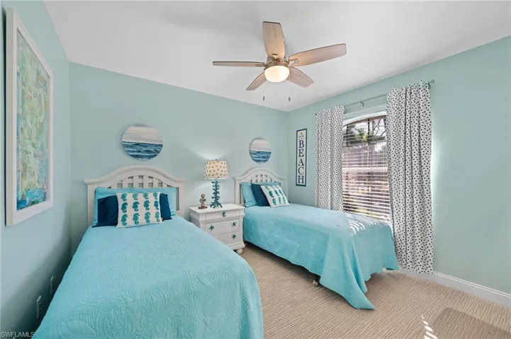Carpeted bedroom with ceiling fan