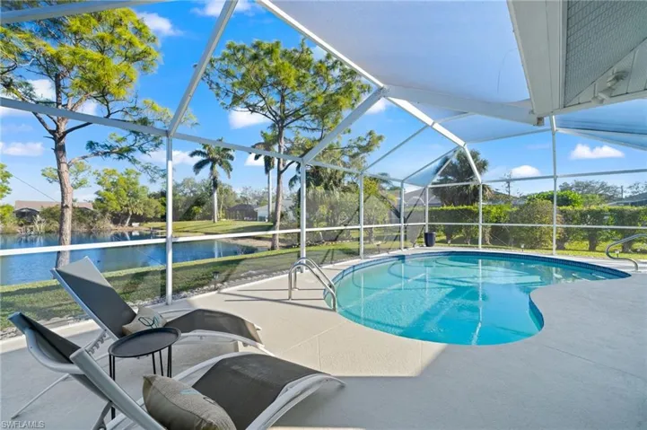 View of pool with a water view, a lanai, and a patio area