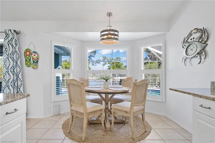 Tiled dining room with a chandelier
