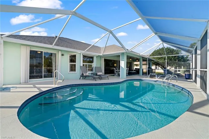 View of pool with ceiling fan, a lanai, and a patio