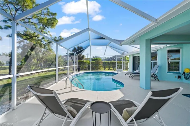 View of pool with a lanai and a patio area