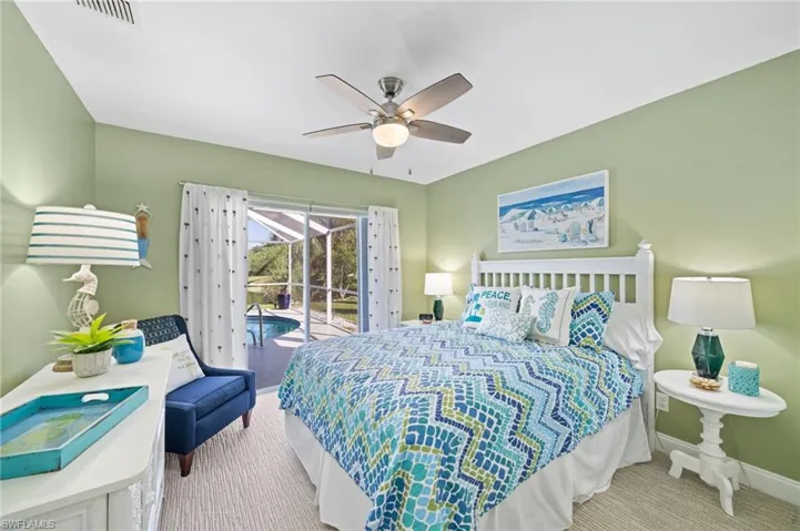 Bedroom featuring access to outside, ceiling fan, and light colored carpet