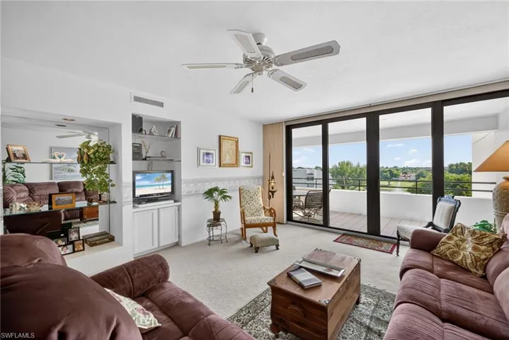 Living room with Hurricane Impact Sliders onto Spacious Balcony