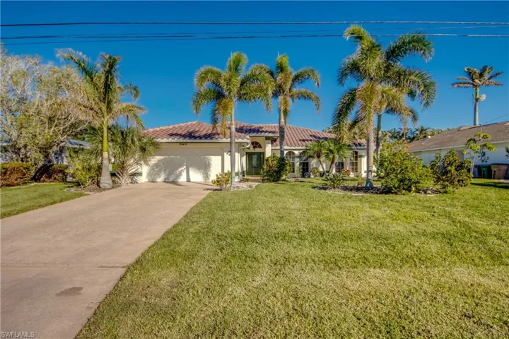 View of front of home featuring a garage and a front lawn