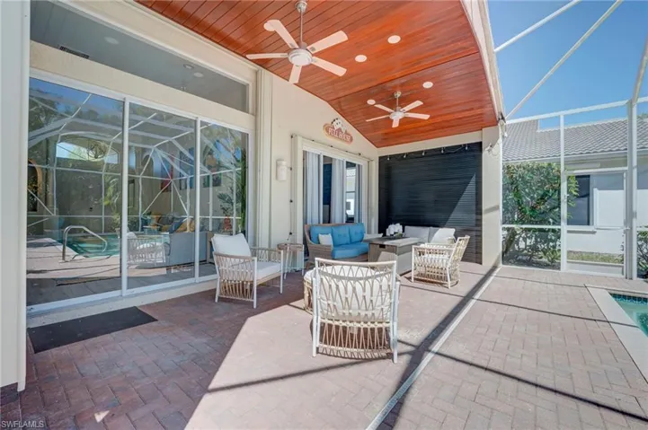 View of patio / terrace featuring enclosure, an outdoor pool, an outdoor lounge area, and ceiling fan
