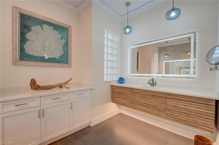 Full bathroom with vanity and dark tile patterned flooring