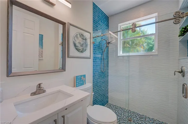 Bathroom featuring vanity and a stall shower