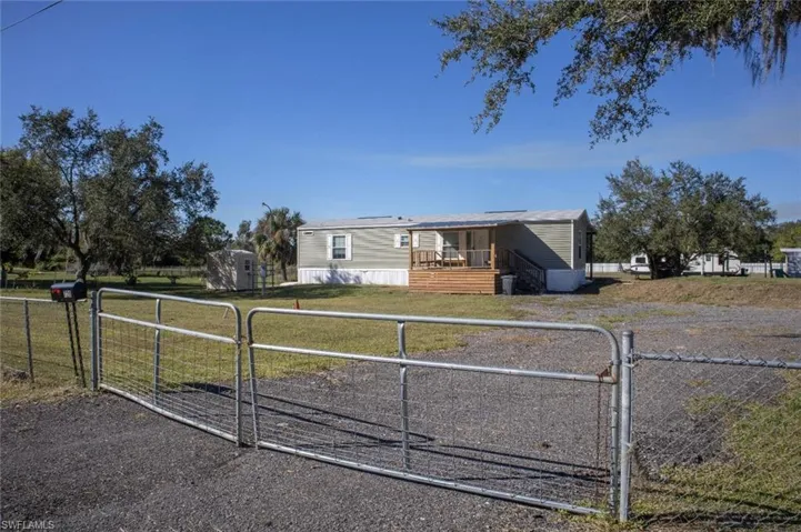 Manufactured / mobile home featuring a gate and a fenced front yard