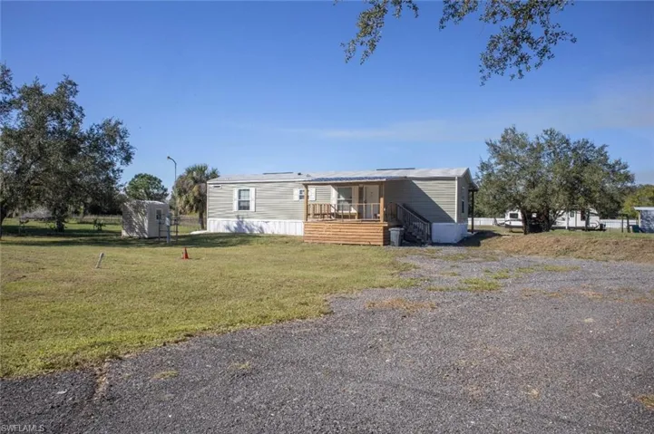 View of front of property featuring a front yard and stairway