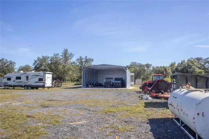 View of yard featuring a carport and a patio