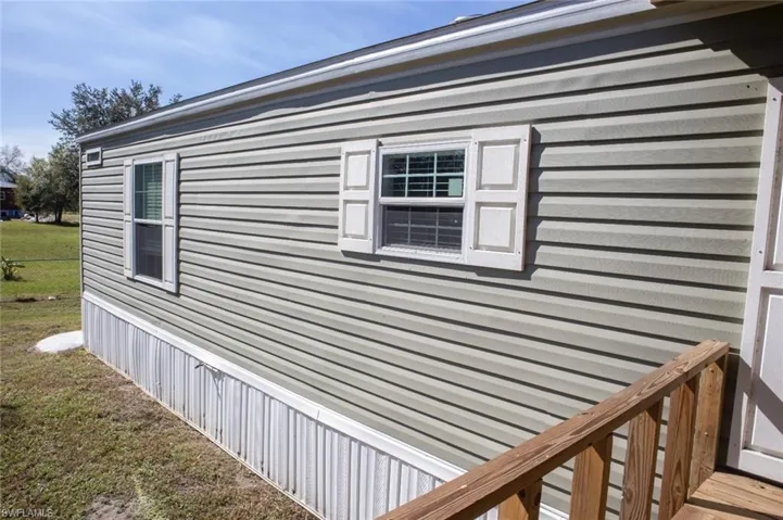 View of side of home featuring a yard