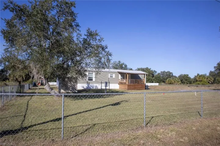 Manufactured / mobile home featuring a fenced backyard
