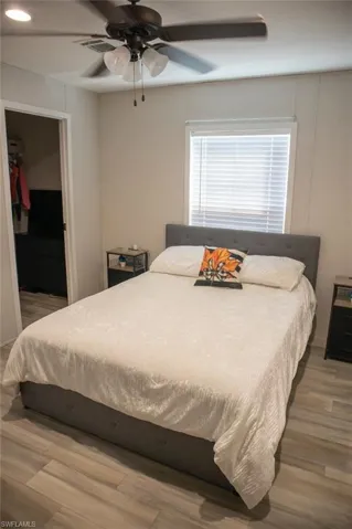 Bedroom featuring light wood-style flooring, ceiling fan, recessed lighting, and a spacious closet