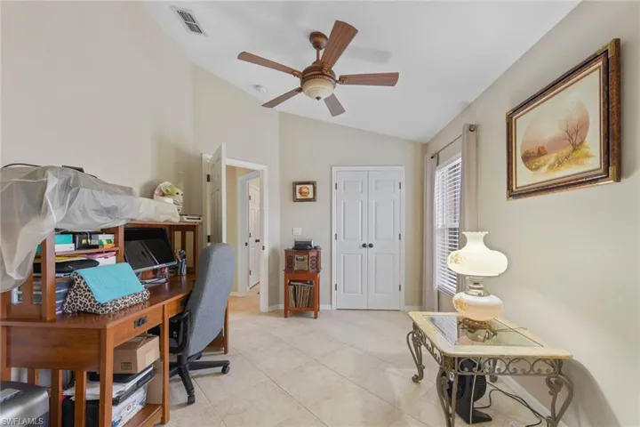 Office area featuring lofted ceiling, ceiling fan, and light tile patterned floors