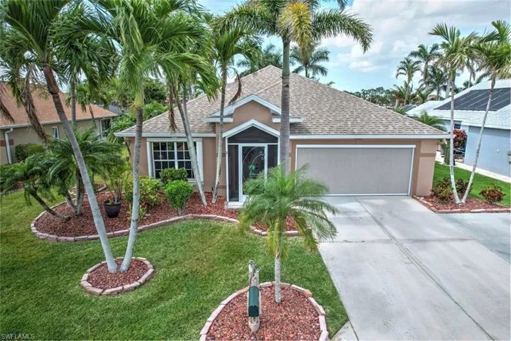 Single story home featuring roof with shingles, concrete driveway, an attached garage, stucco siding, and a front yard
