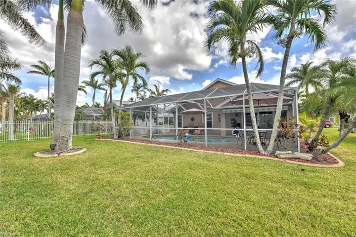 Fenced backyard with a sunroom, a lanai, and a patio area
