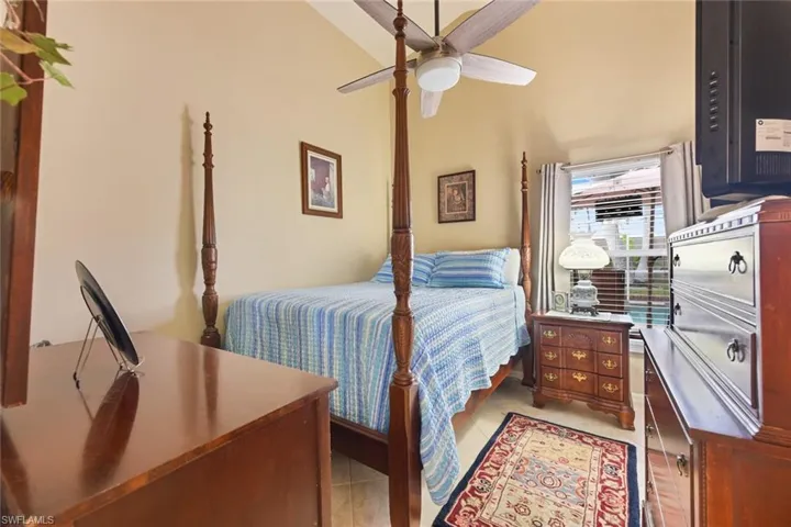 Bedroom featuring light tile patterned floors and a ceiling fan