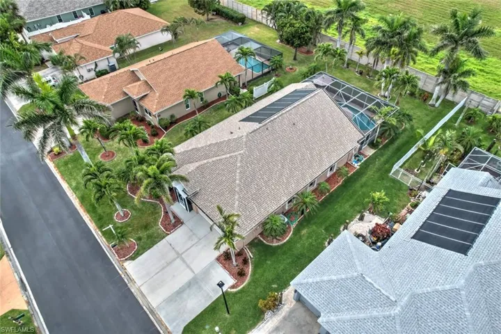 Aerial view of property and surrounding area with nearby suburban area