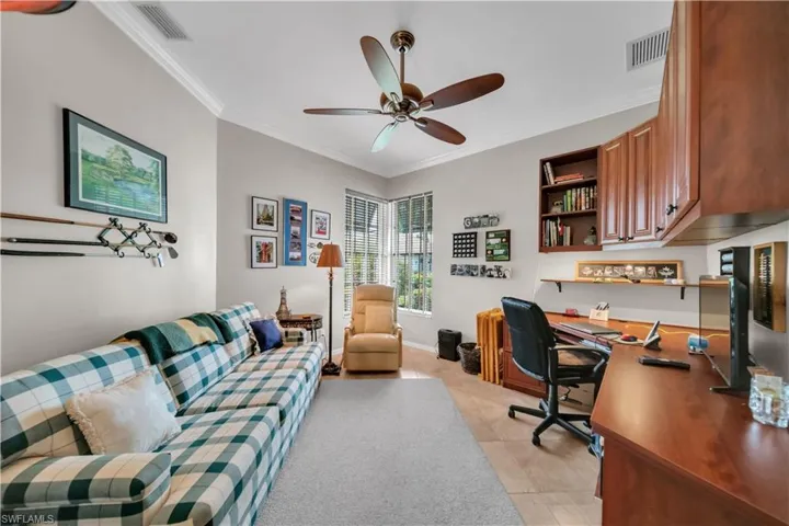 Home office featuring crown molding and a ceiling fan