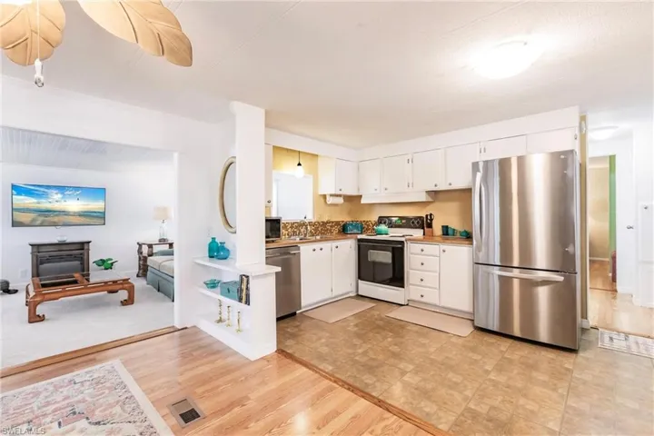 Kitchen featuring stainless steel appliances, a ceiling fan, visible vents, and white cabinetry