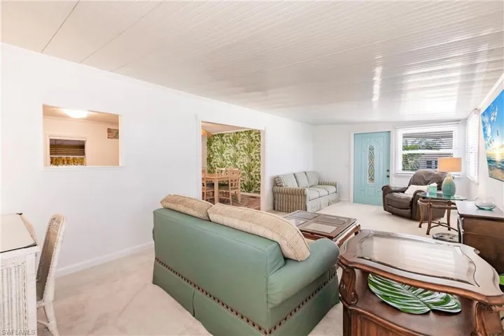 Living area featuring carpet flooring and baseboards