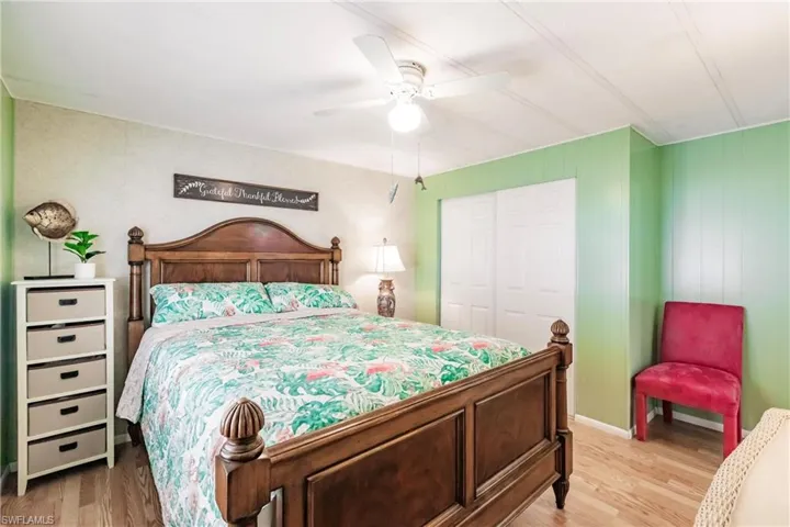 Bedroom featuring light wood-style flooring, a closet, and a ceiling fan