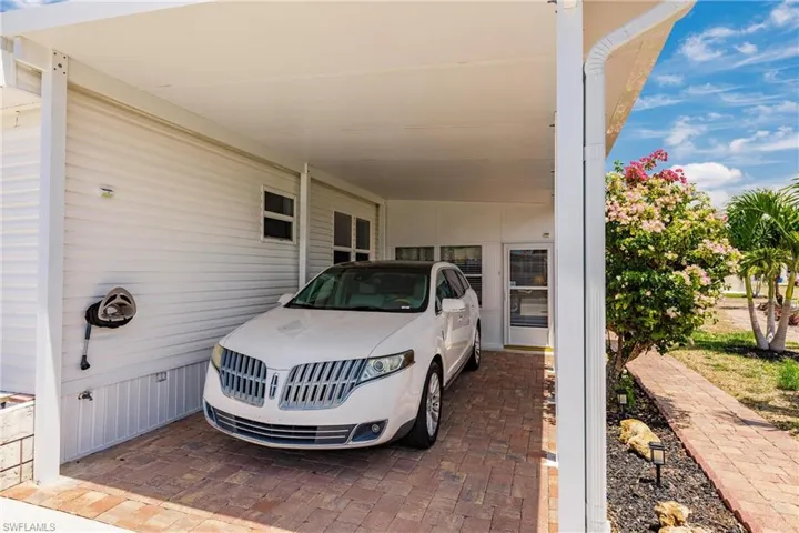 View of parking with a carport