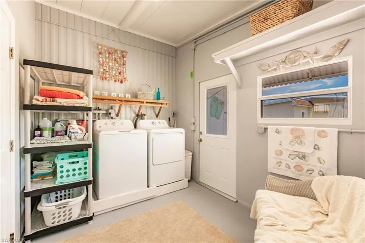 Washroom with separate washer and dryer and laundry area