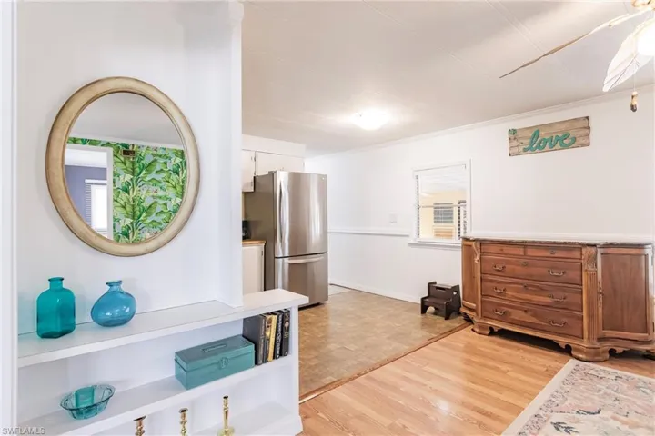 Bedroom featuring light wood finished floors and freestanding refrigerator