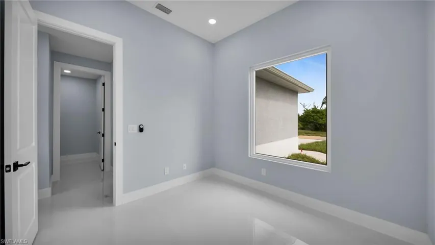 Spare room with baseboards and recessed lighting
