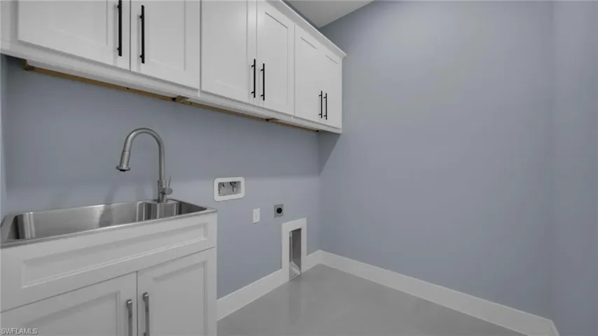 Laundry room featuring cabinet space, hookup for an electric dryer, and washer hookup
