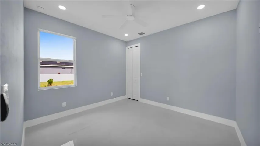 Spare room with a ceiling fan, concrete floors, and recessed lighting