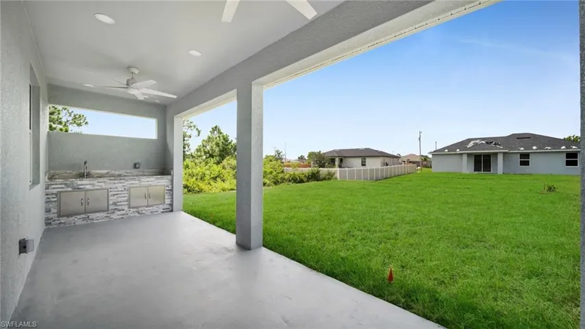 View of patio featuring a ceiling fan and exterior kitchen