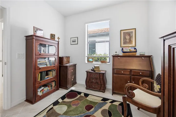 Sitting room featuring light tile patterned flooring and baseboards