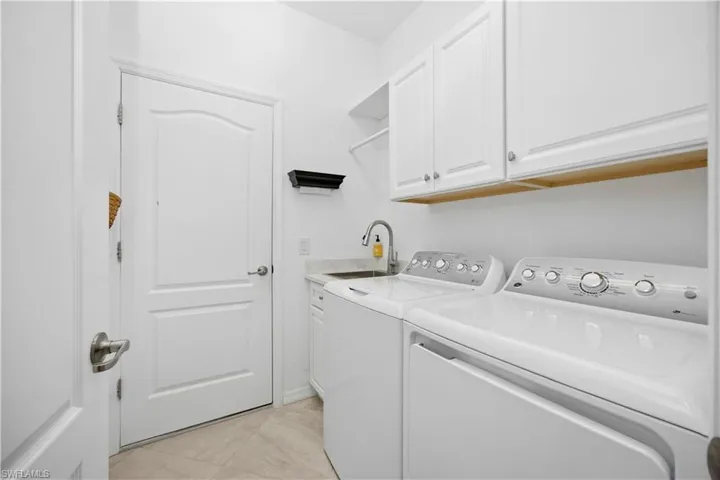 Laundry room with washing machine and dryer and cabinet space