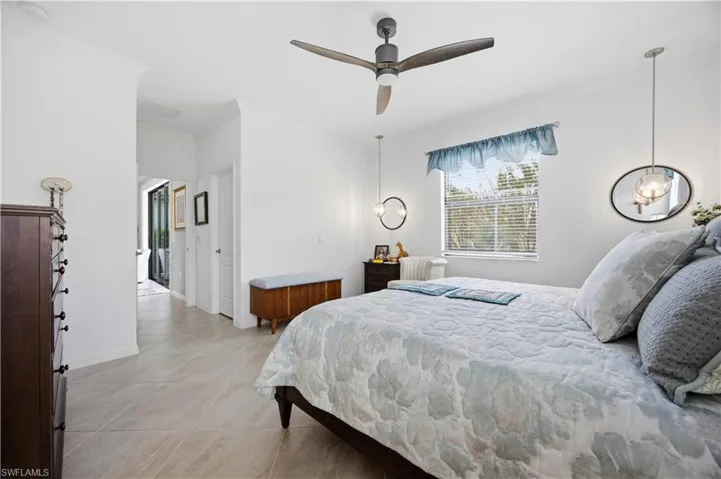 Bedroom featuring ornamental molding and ceiling fan