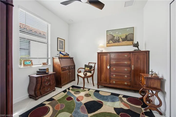 Sitting room featuring a ceiling fan and light tile patterned floors