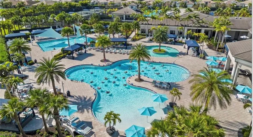 View of pool with a patio and a hot tub