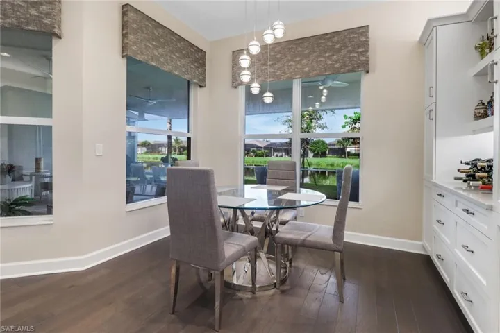 Dining room featuring a chandelier and dark hardwood flooring