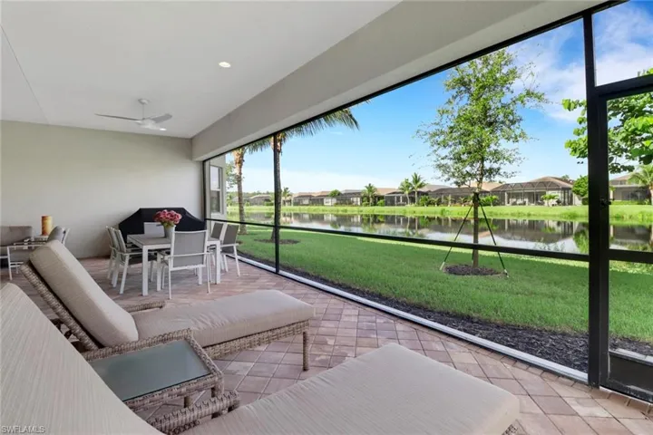 Sunroom with a water view and ceiling fan