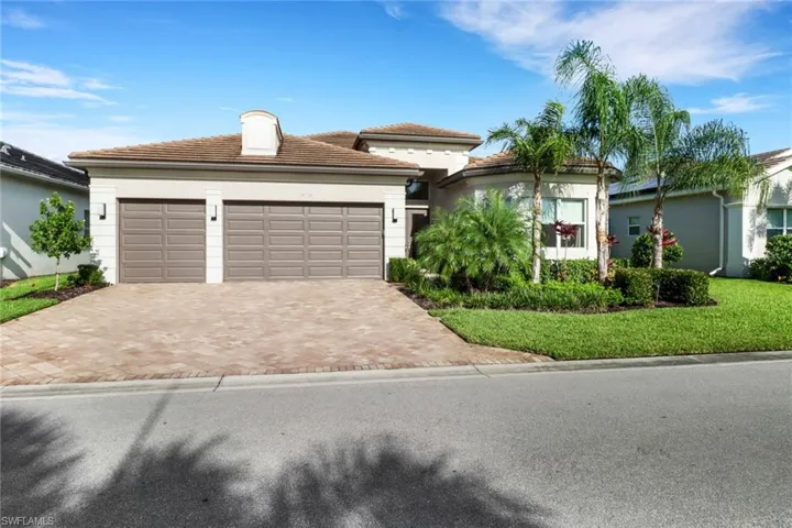 View of front facade with a garage and a front lawn