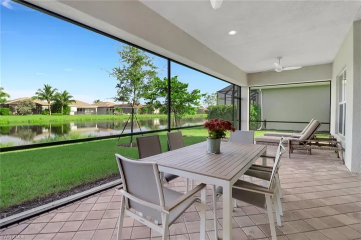 Sunroom with a water view and ceiling fan
