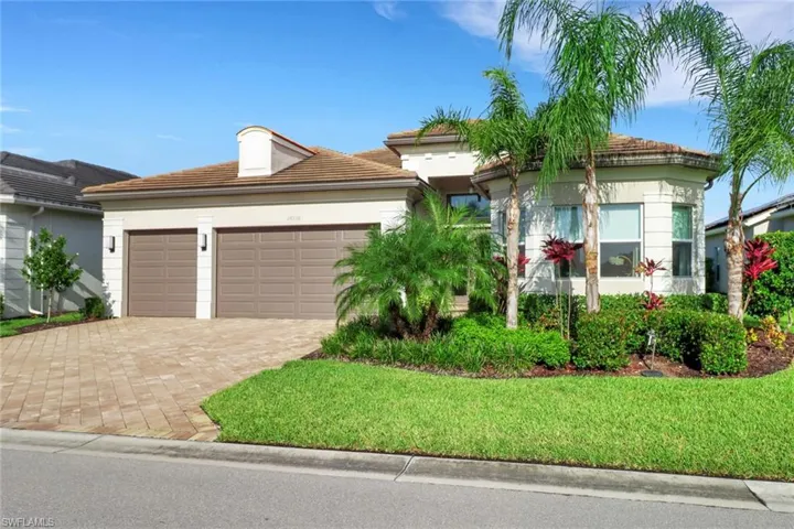 View of front of property featuring a garage and a front yard