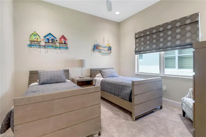 Carpeted bedroom featuring ceiling fan