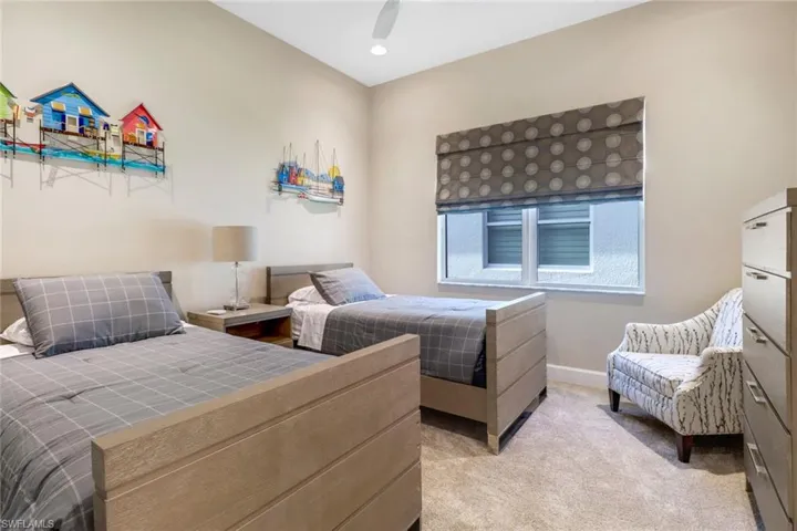 Carpeted bedroom featuring ceiling fan