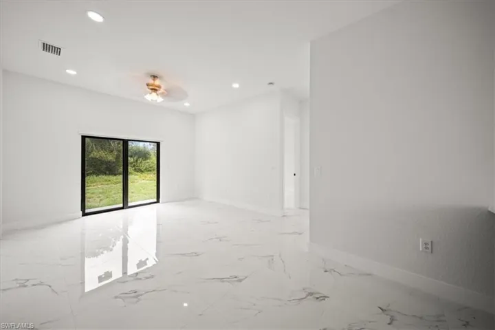 Unfurnished room with light marble finish flooring, recessed lighting, and a ceiling fan